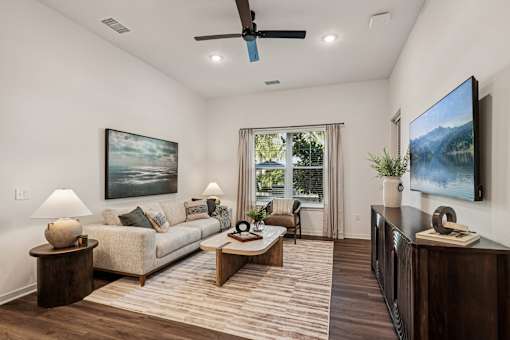 A living room with a couch, a coffee table, and a television at The Stadler Luxury Apartments, Bradenton, 34210