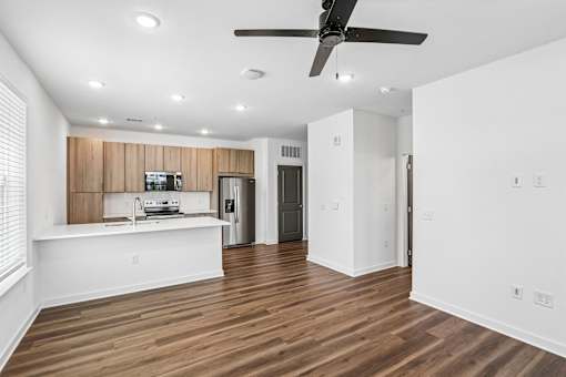 Open concept kitchen with wood cabinetry and island at Velara Luxury Apartments, Ponte Vedra Beach, Florida