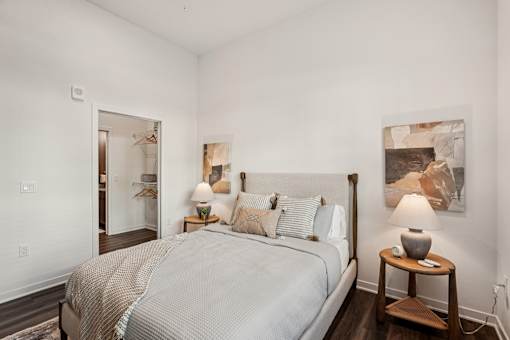 A bedroom with a large bed and a painting on the wall at The Stadler Luxury Apartments, Bradenton, Florida