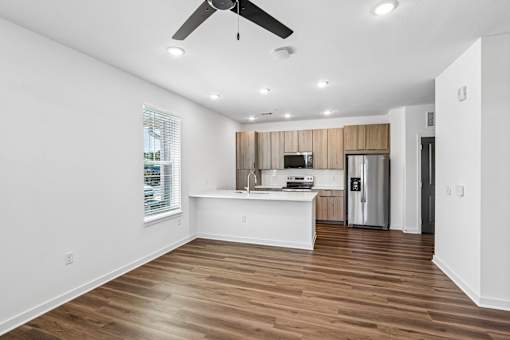 Open concept kitchen with wood cabinets and island at Velara Luxury Apartments, Ponte Vedra Beach