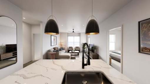 A modern kitchen with a marble countertop and a large island.at Terrassa Luxury Apartments, Saint Augustine, 32084