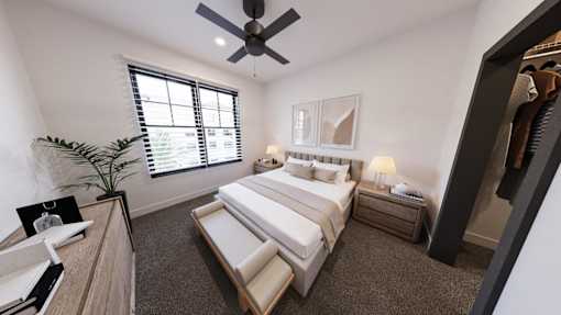 A bedroom with a large bed, a ceiling fan, and a window with blinds.