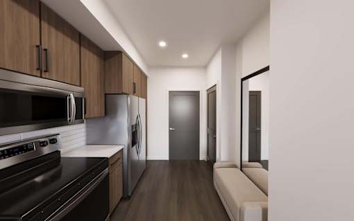 Kitchen with brown cabinets at The Union Flats at Fishers District, Fishers, IN