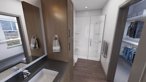 A modern bathroom with a sink, mirror, and wooden cabinets at Refinery at Pointe17 Apartments, Phoenix, AZ