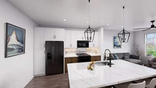 A modern kitchen with a large island and a refrigerator at Refinery at Pointe17 Apartments, Arizona, 85085