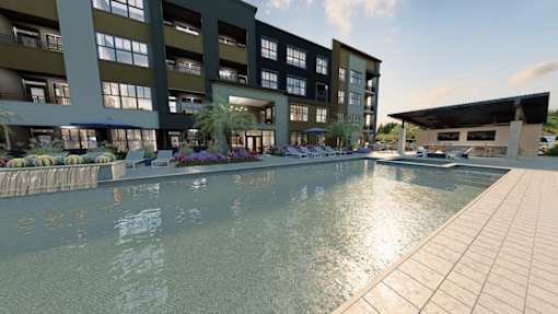 A large building with a pool in front.