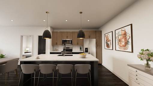 A modern kitchen with a large island and chairs.