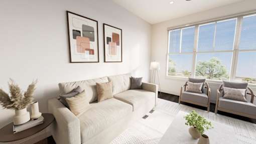 A living room with a white couch, two chairs, and two framed pictures on the wall.
