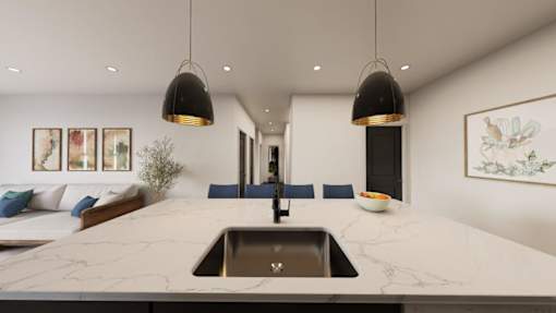 A modern kitchen with a marble countertop and a sink.