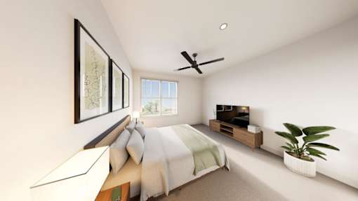A bedroom with a bed, a ceiling fan, and a plant.