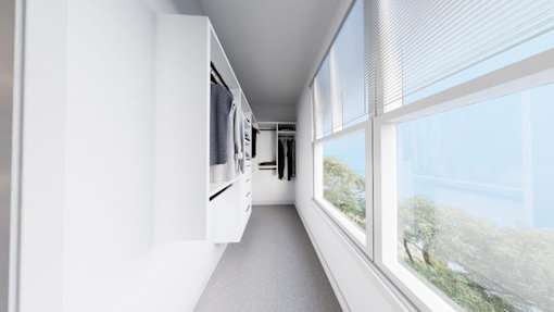 A long white hallway with a window on the right side.
