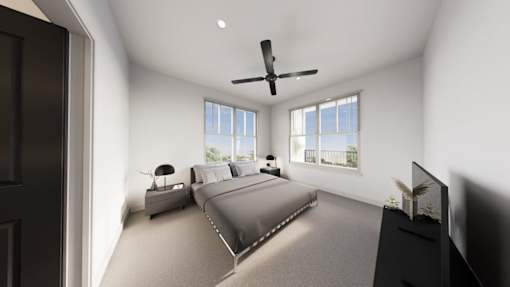 A bedroom with a large bed and a ceiling fan.