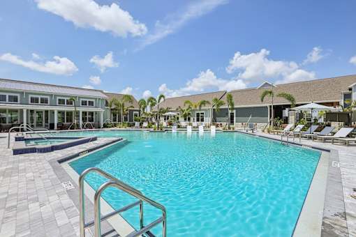 A large swimming pool with a metal railing on the left side.