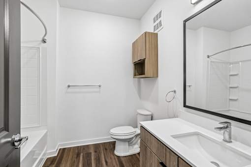 Modern bathroom with wood vanity and subway tile shower at Velara Luxury Apartments, Ponte Vedra Beach, FL 32081