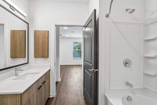 Bathroom with tub shower combo and wood vanity at Velara Luxury Apartments, Ponte Vedra Beach, FL