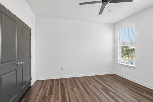 Empty bedroom with wood flooring and ceiling fan at Velara Luxury Apartments, Ponte Vedra Beach, 32081