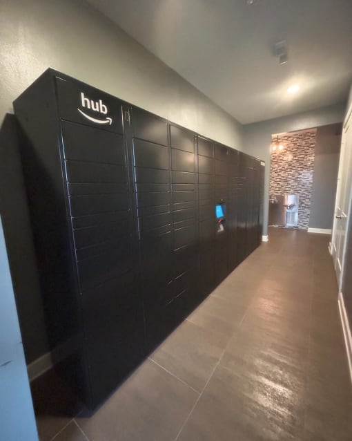 a row of black lockers in a hallway at Watermark at Steele Crossing, Arkansas, 72703