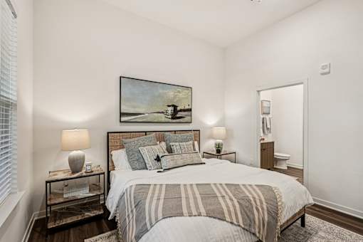 A bedroom with a large bed and a painting on the wall at The Stadler Luxury Apartments, Florida