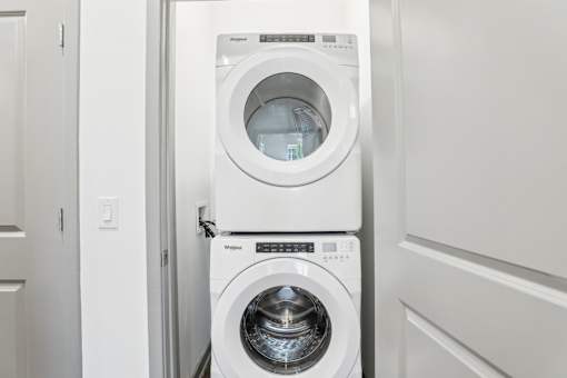A white washing machine and dryer in a laundry room.