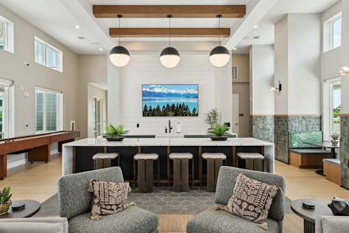 A modern kitchen with a large island and bar stools.