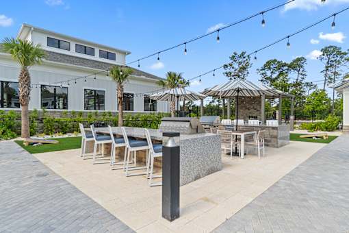 A patio area with a table and chairs under a gazebo.