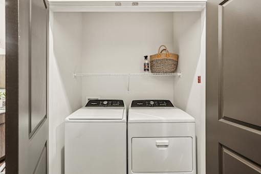 A small laundry room with a washer and dryer at The Stadler Luxury Apartments, Bradenton, FL 34210