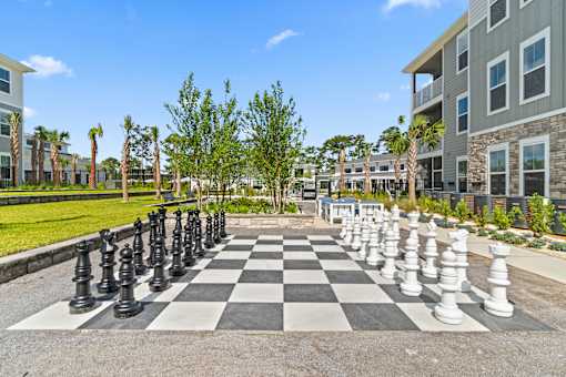 A giant chess board in the middle of a courtyard.