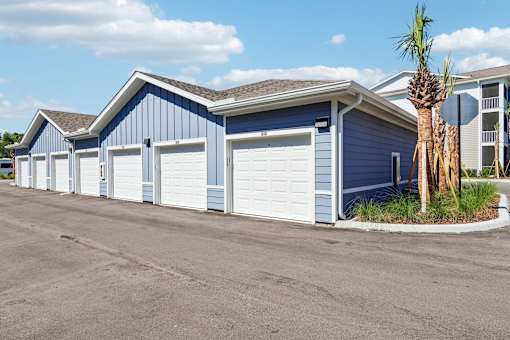 Row of private garages with white doors at Velara Luxury Apartments, Ponte Vedra Beach, FL