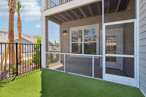 Screened patio with artificial turf and sliding door at Velara Luxury Apartments, Ponte Vedra Beach, 32081