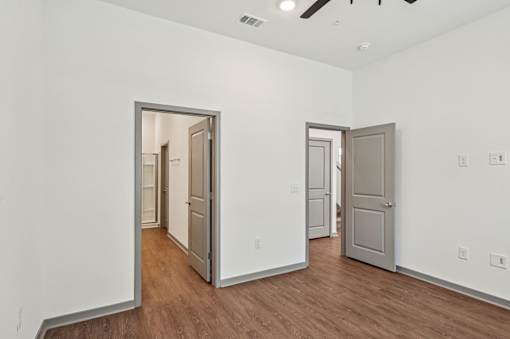 A room with two doors and wooden floors. at The Sophia, Venice, FL