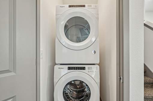 A white washing machine is stacked on top of another white washing machine. at The Sophia, Venice, FL