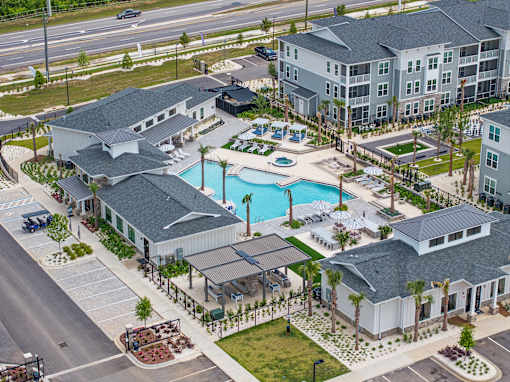 A large building with a pool in front of it.