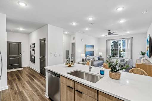 Kitchen island with sink overlooking living area at Velara Luxury Apartments, Ponte Vedra Beach, 32081