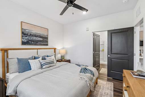 Bedroom with wooden bed frame and ceiling fan at Velara Luxury Apartments, Florida, 32081