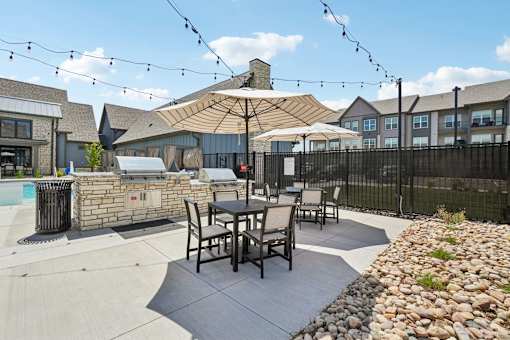 Pool deck patio furniture with umbrellas.