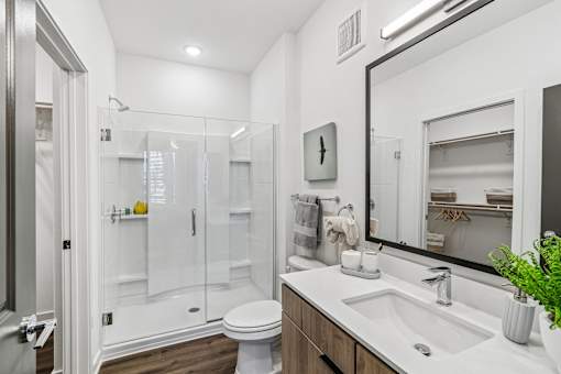 Modern bathroom with glass shower and double vanity at Velara Luxury Apartments, Ponte Vedra Beach, FL 32081