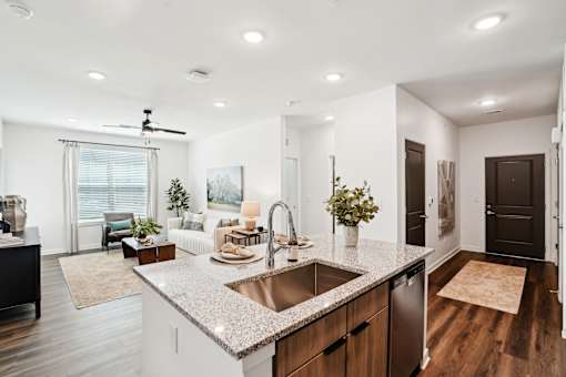 A modern kitchen with a large island and a dining area. at The Pullman Luxury Apartments, Atlanta, Georgia