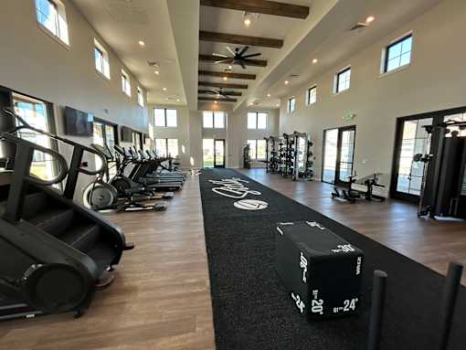 A gym with treadmills, elliptical machines, and other exercise equipment.