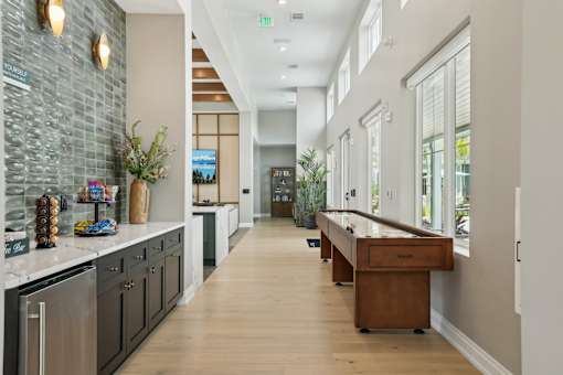 A long hallway with a counter on the left and a door at the end.