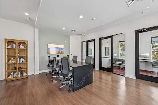 A room with a black table and chairs with a view of the outside. at The Hadley - North Port, FL Apartments, Florida