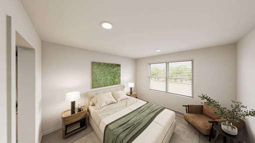 A bedroom with a bed, nightstand, and chair.