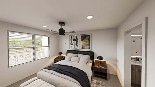 A bedroom with a large bed and a ceiling fan.