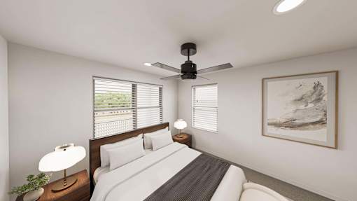 A bedroom with a bed, a ceiling fan, and a window with blinds.