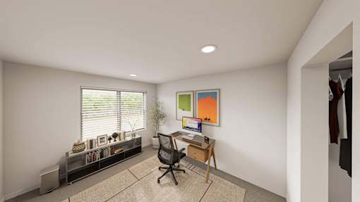 A room with a desk, chair, and a window with blinds.
