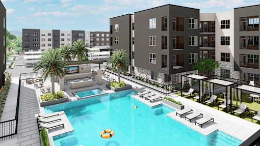 A pool surrounded by lounge chairs and umbrellas is the centerpiece of a resort-style courtyard at Refinery at Pointe17 Apartments, Phoenix, AZ, 85085