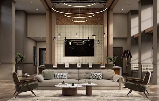 A modern living room with a large couch, a coffee table, and a TV mounted on the wall.
