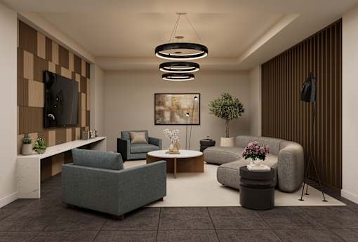 A modern living room with a grey sofa, a coffee table, and a TV on the wall.