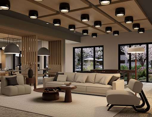 A modern living room with a large window and a view of trees outside.