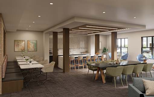 A modern dining room with a long table and chairs.