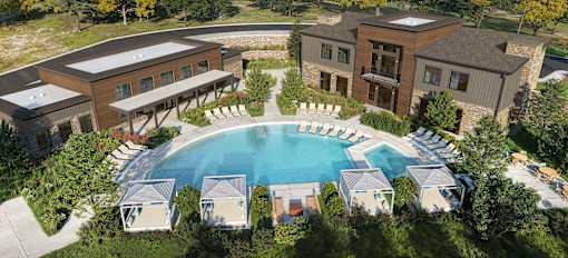 A large building with a pool in front of it.